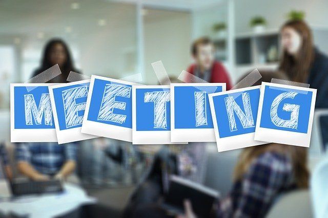 This is a meme with people and the word meeting across the front.