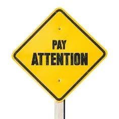 This is a graphic of a sign that says Pay Attention.