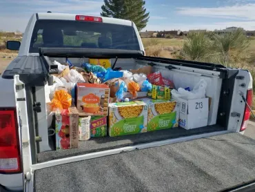 This is a photograph of a pick up truck filled with food.