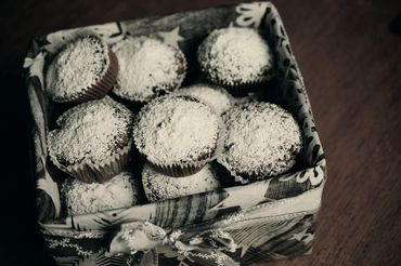 This is a photograph of muffins in a decorated container.