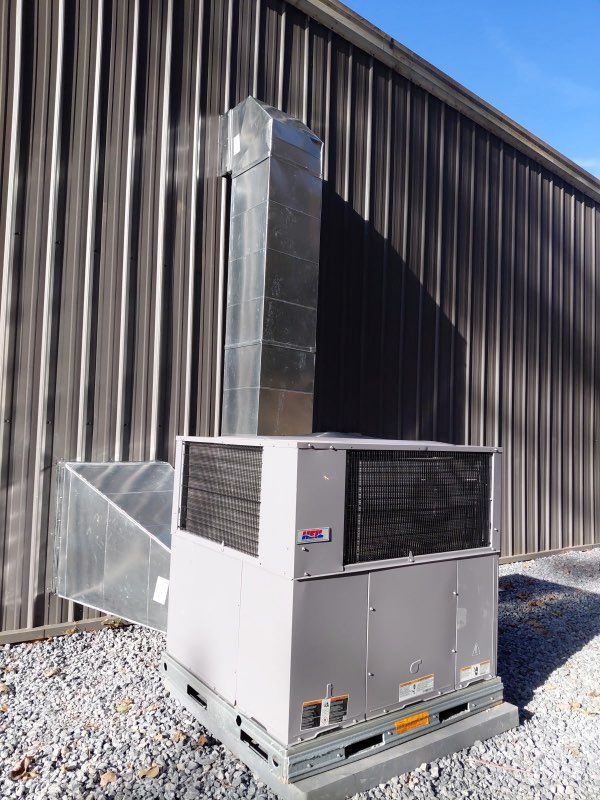 A beige outdoor air conditioning unit.