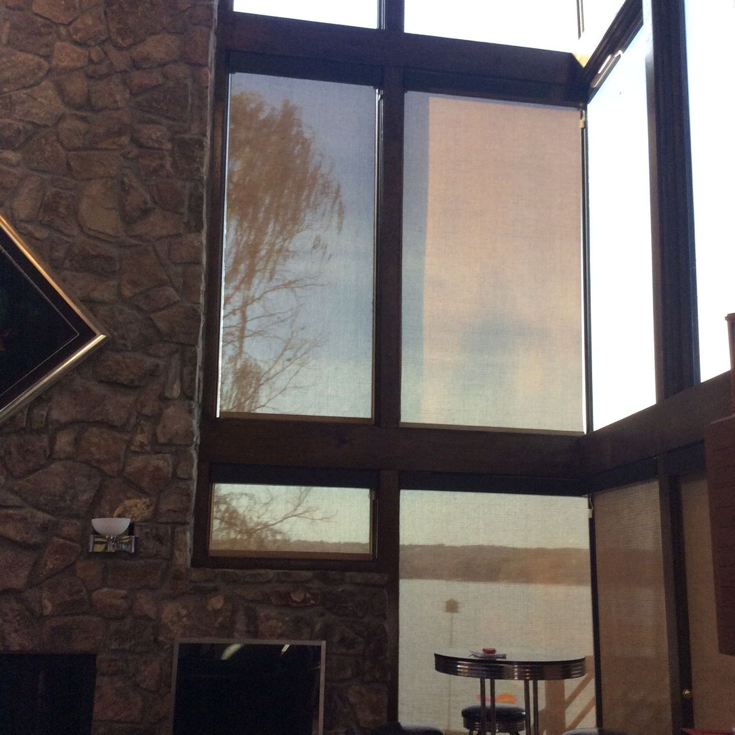 A living room with a fireplace and lots of windows