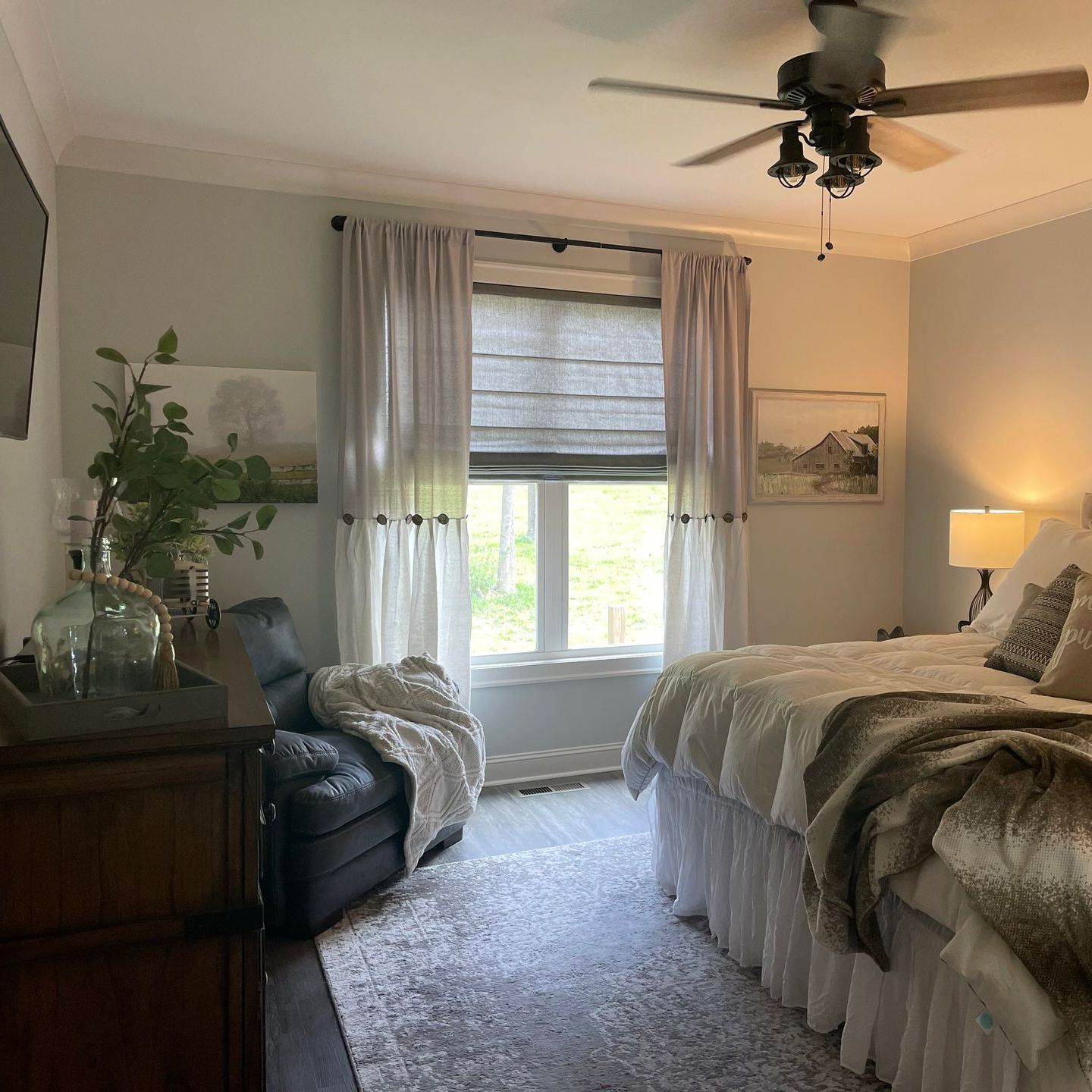 A bedroom with two beds and a ceiling fan