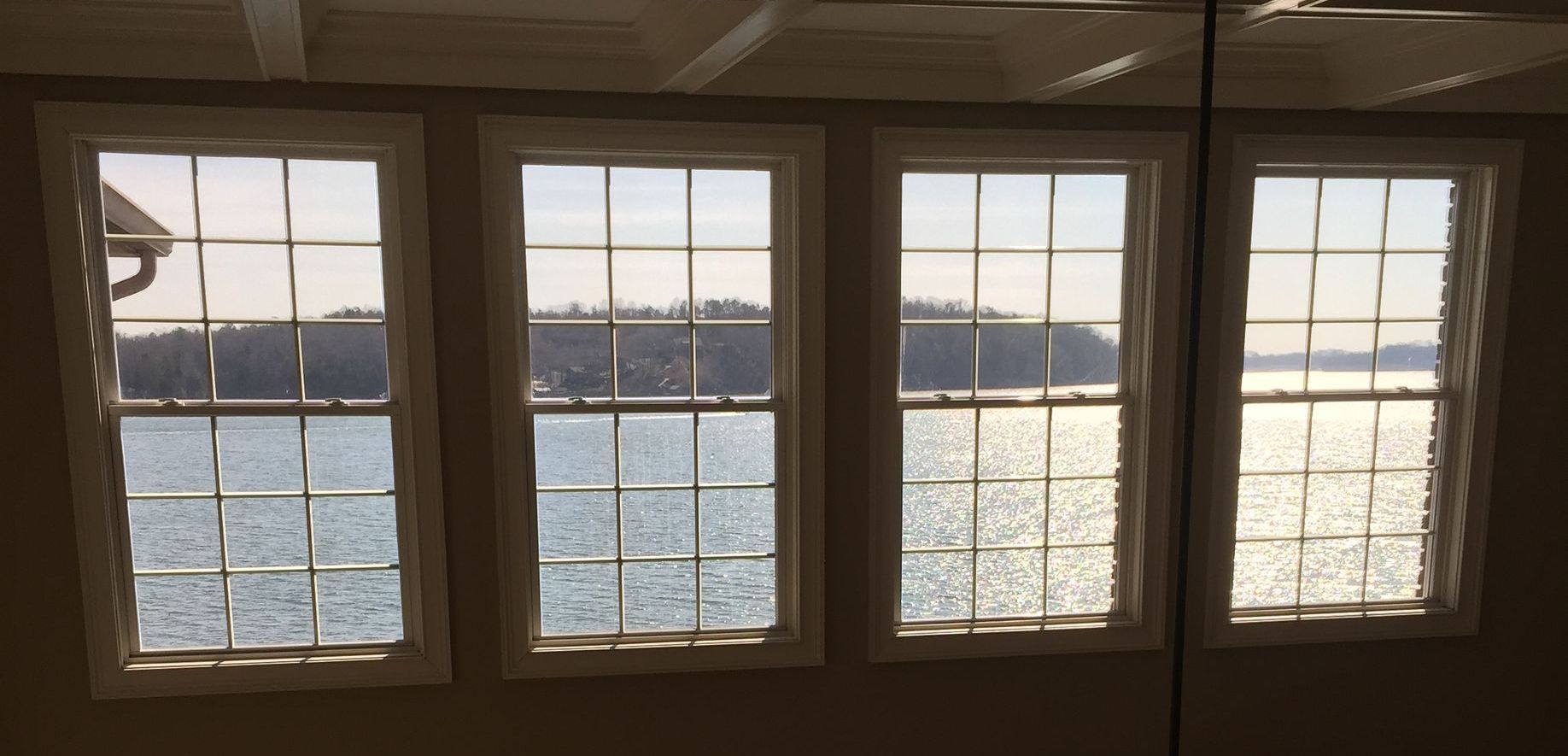 Three windows with a view of a body of water