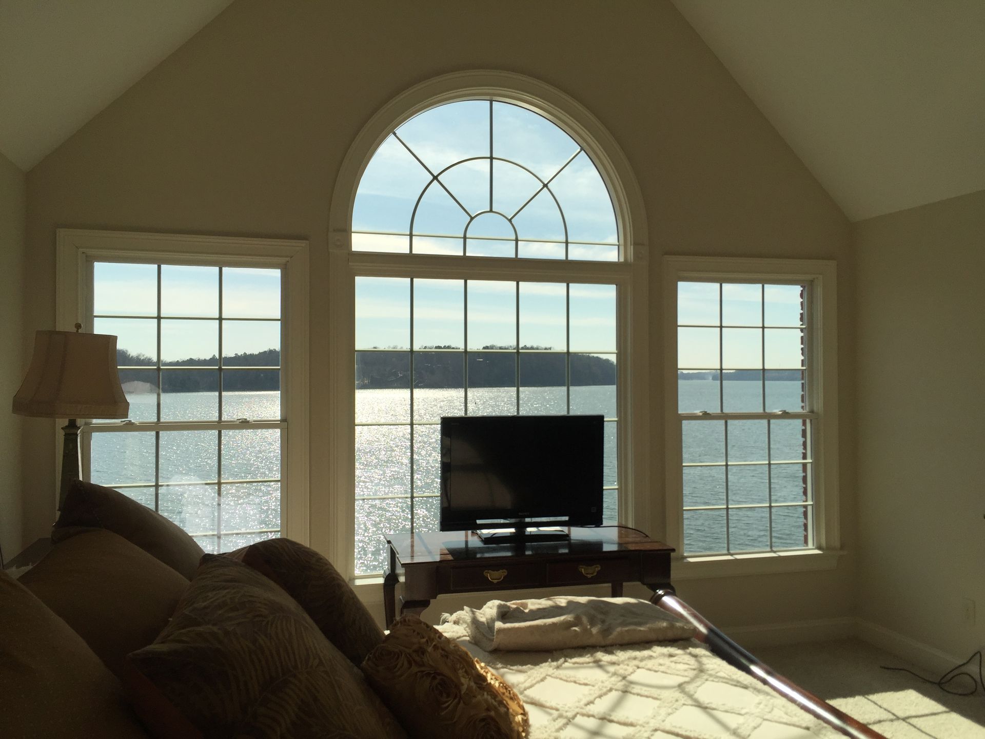 A living room with a large window overlooking the ocean