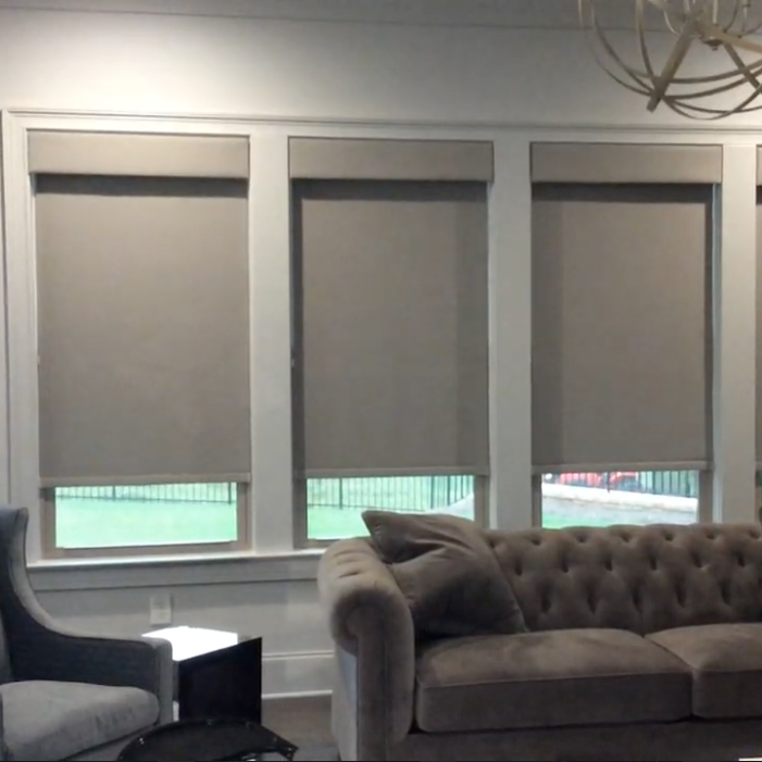 A living room with a couch a chair and a chandelier