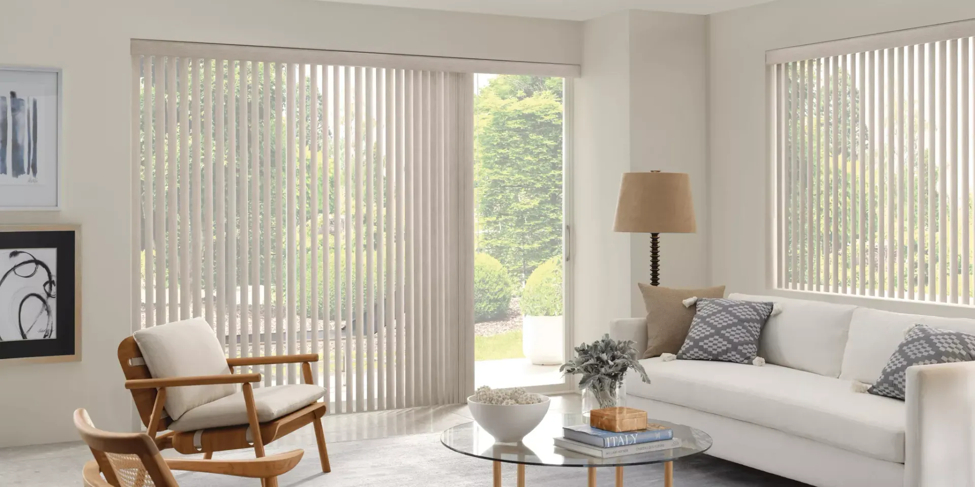 A living room with a couch , chair , table and blinds.