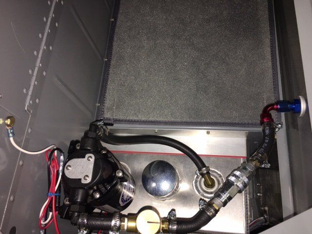 A metal box with a pump and hose attached to it