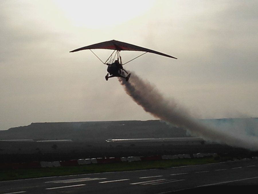 A person is flying a small plane with smoke coming out of it