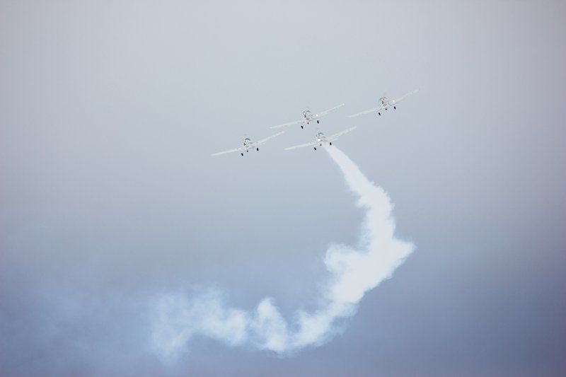 A group of jets are flying through a cloudy sky.