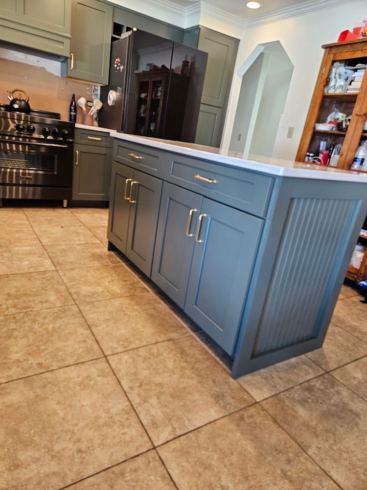 A kitchen with a large island in the middle of it.