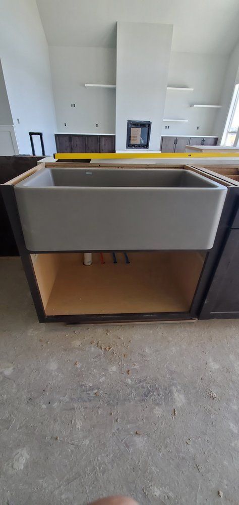 A kitchen sink is being built in a kitchen.
