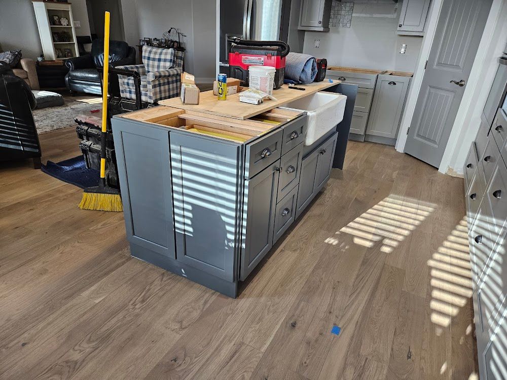 A kitchen is being remodeled with a large island and a sink.