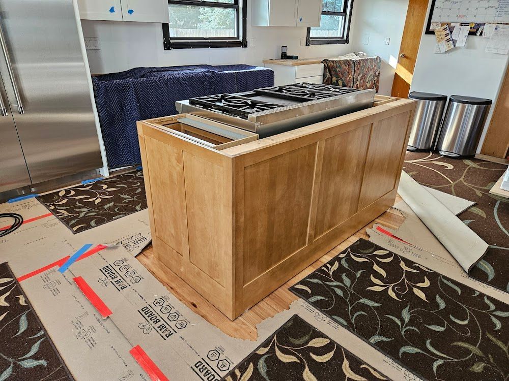 A kitchen island with a stove top oven on top of it