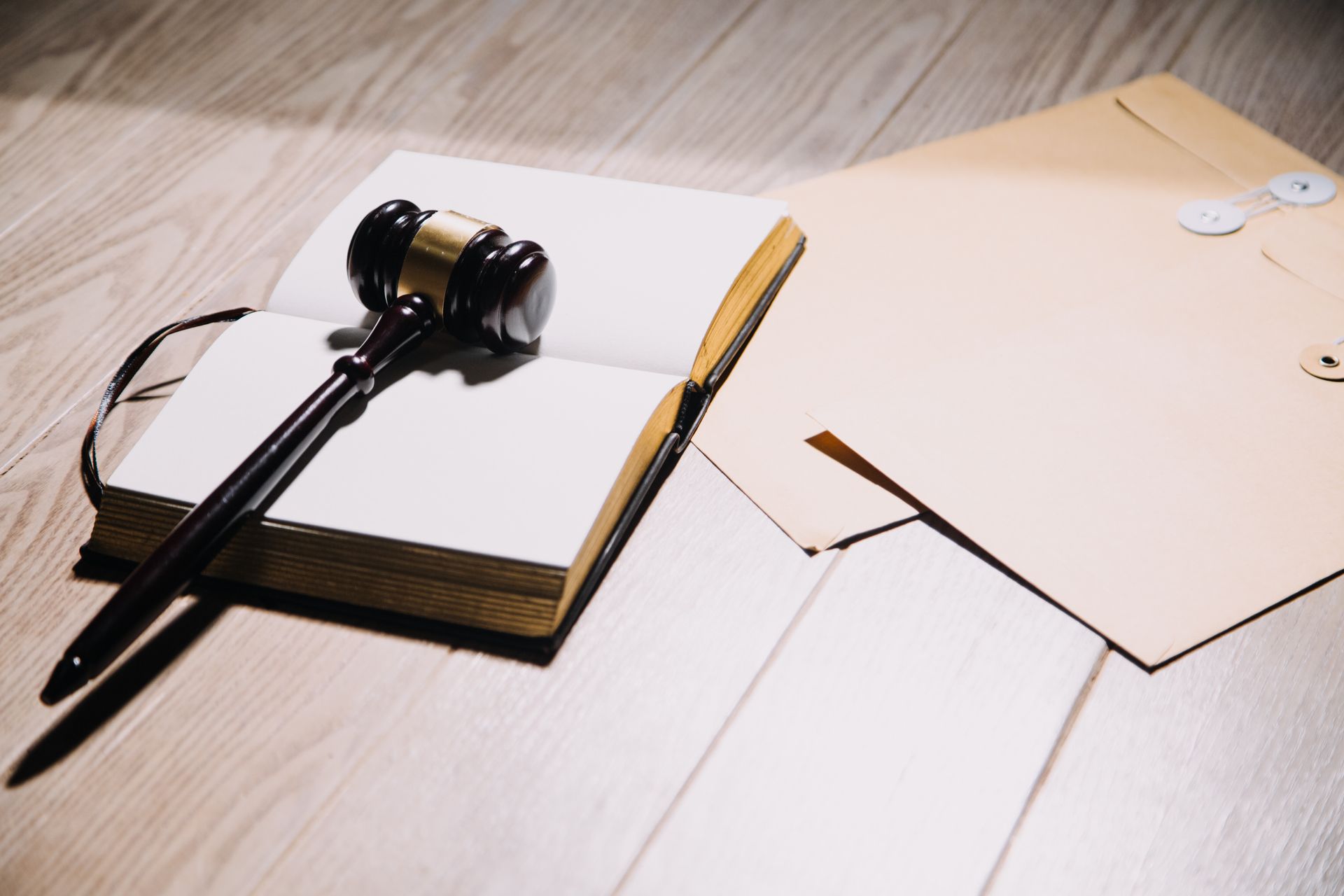 A judge 's gavel is sitting on top of an open notebook.