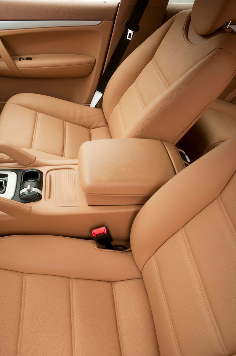 Tan leather car interior with front seats and center console.