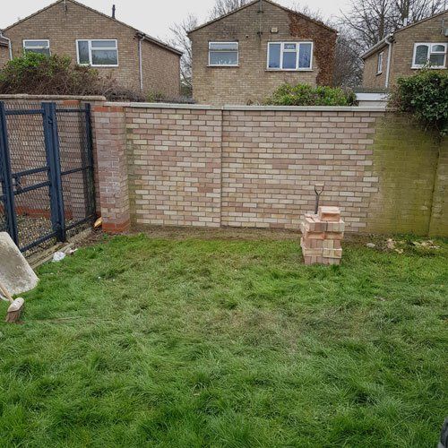Raised patio and wall being built in garden