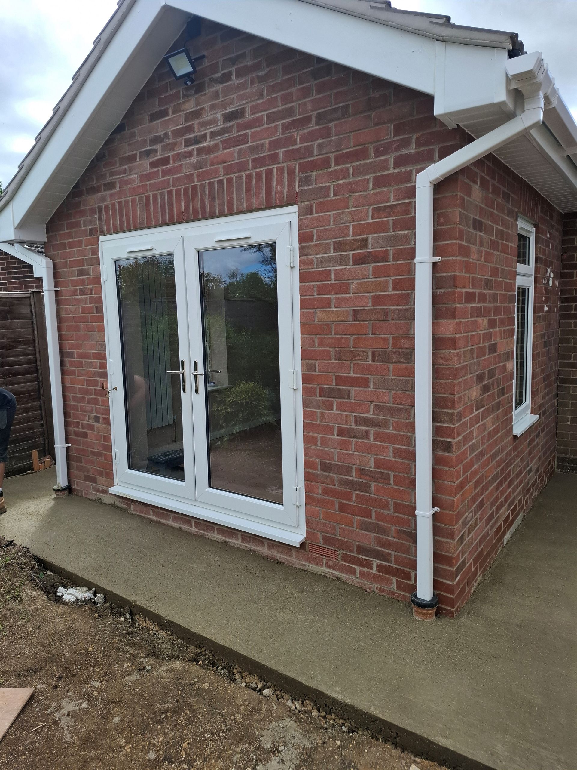 Raised patio and wall being built in garden