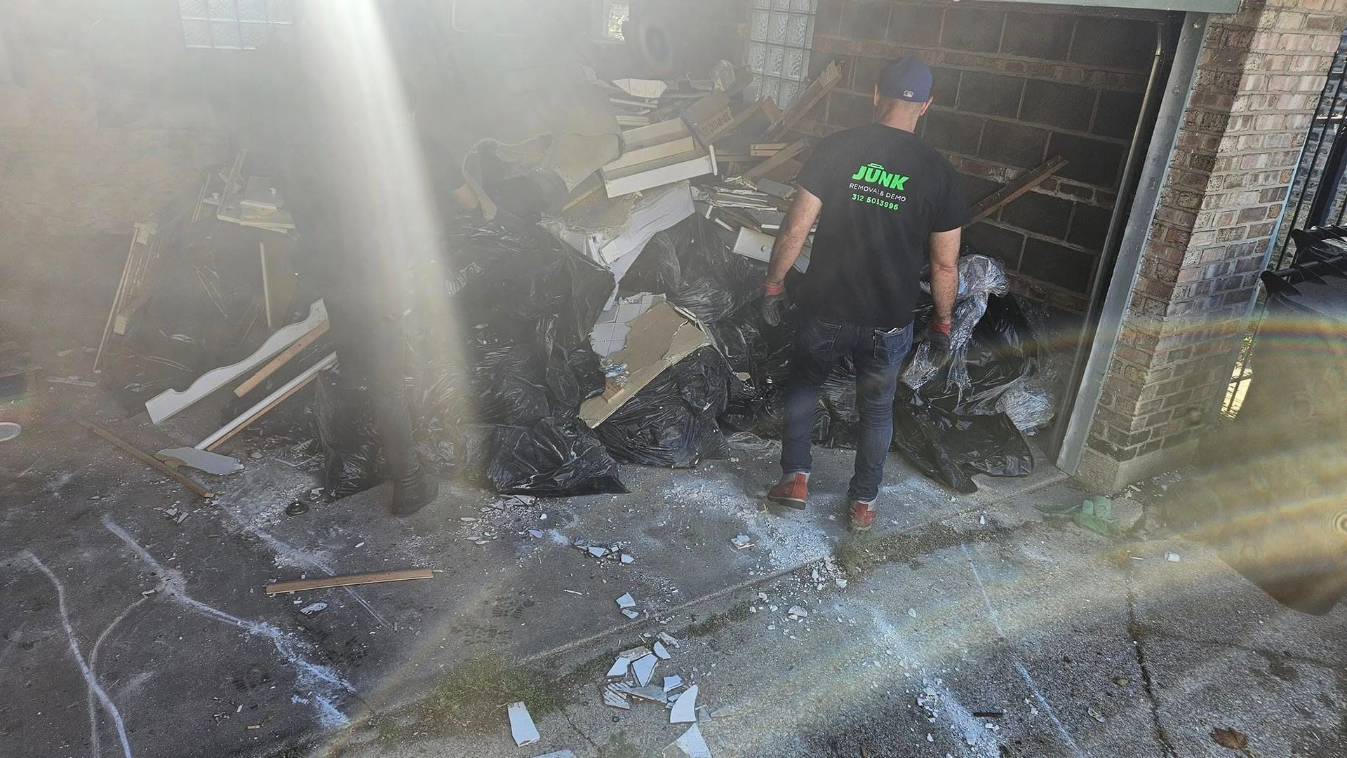 A man is standing in a garage with smoke coming out of it.