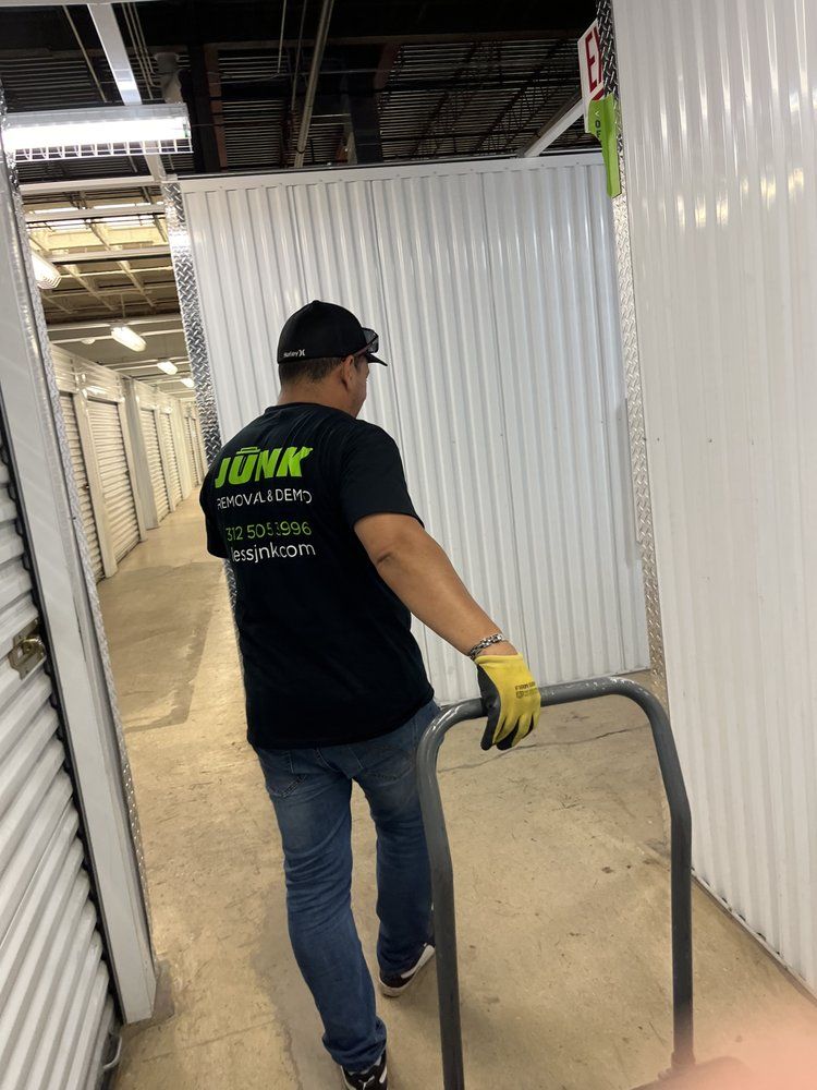 A man is pushing a cart in a storage unit.