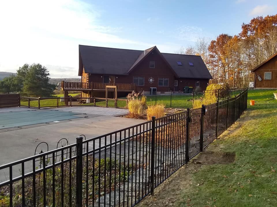 A large house with a fence in front of it