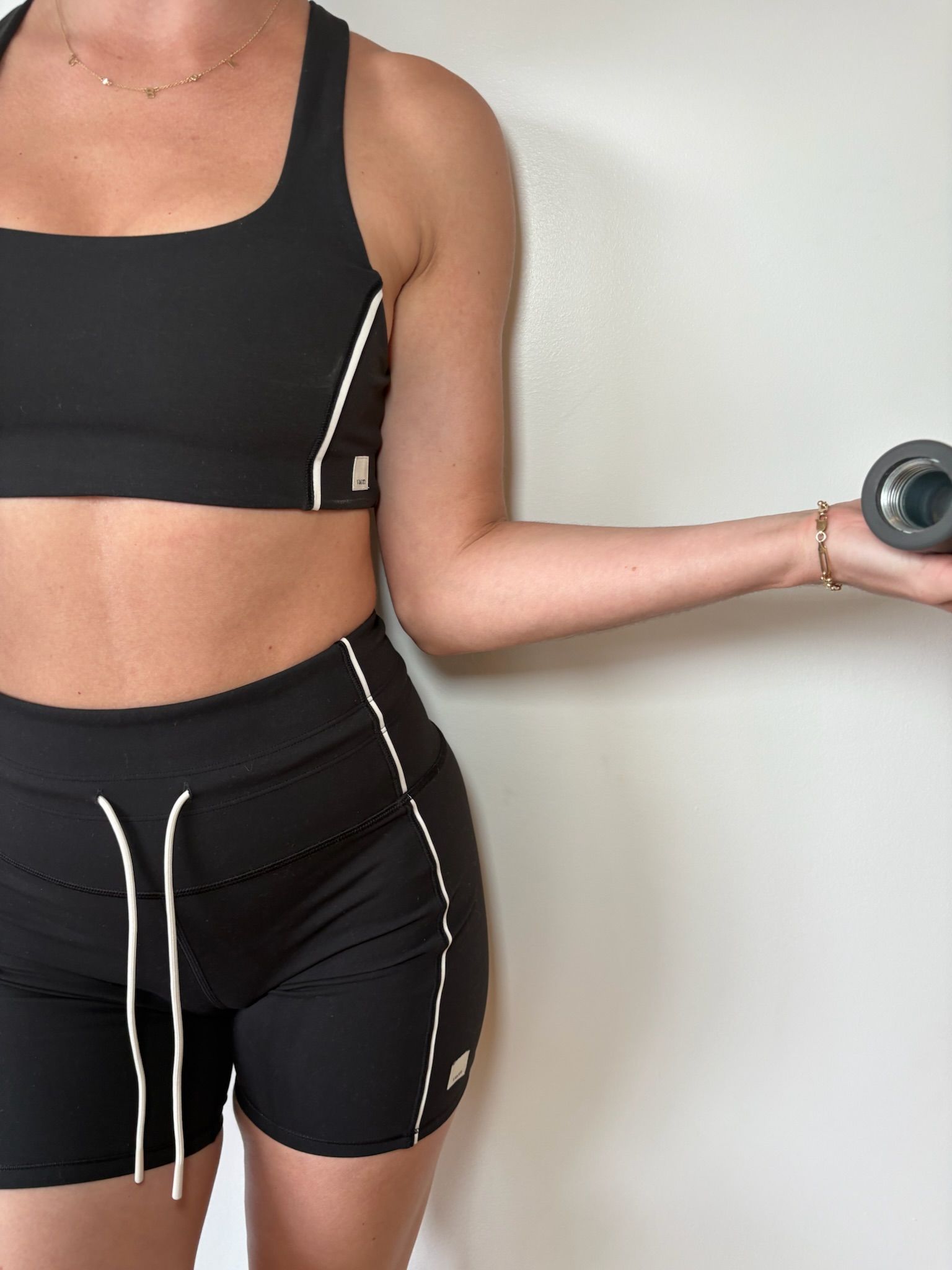an instructor holds a weight for a bicep curl