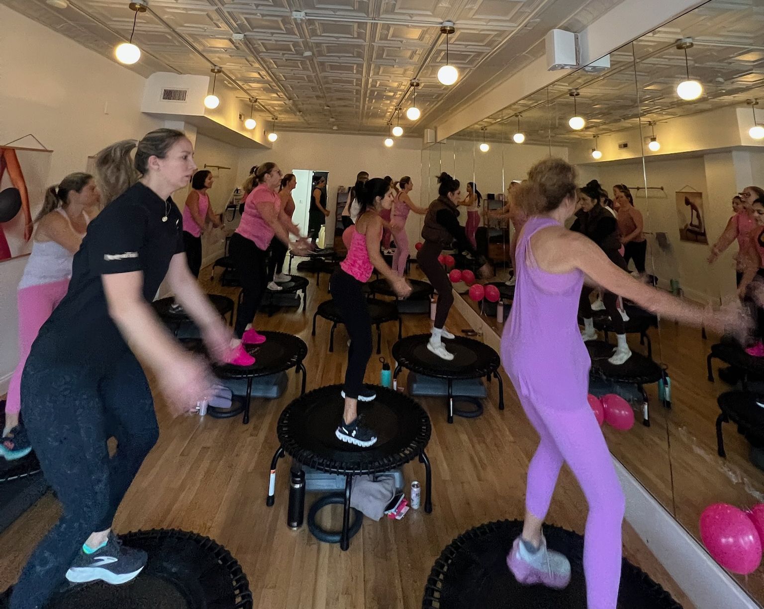 an instructor holds a weight for a bicep curl