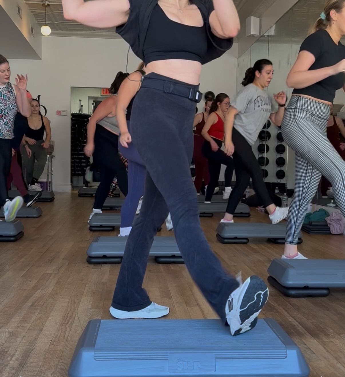 an instructor holds a weight for a bicep curl