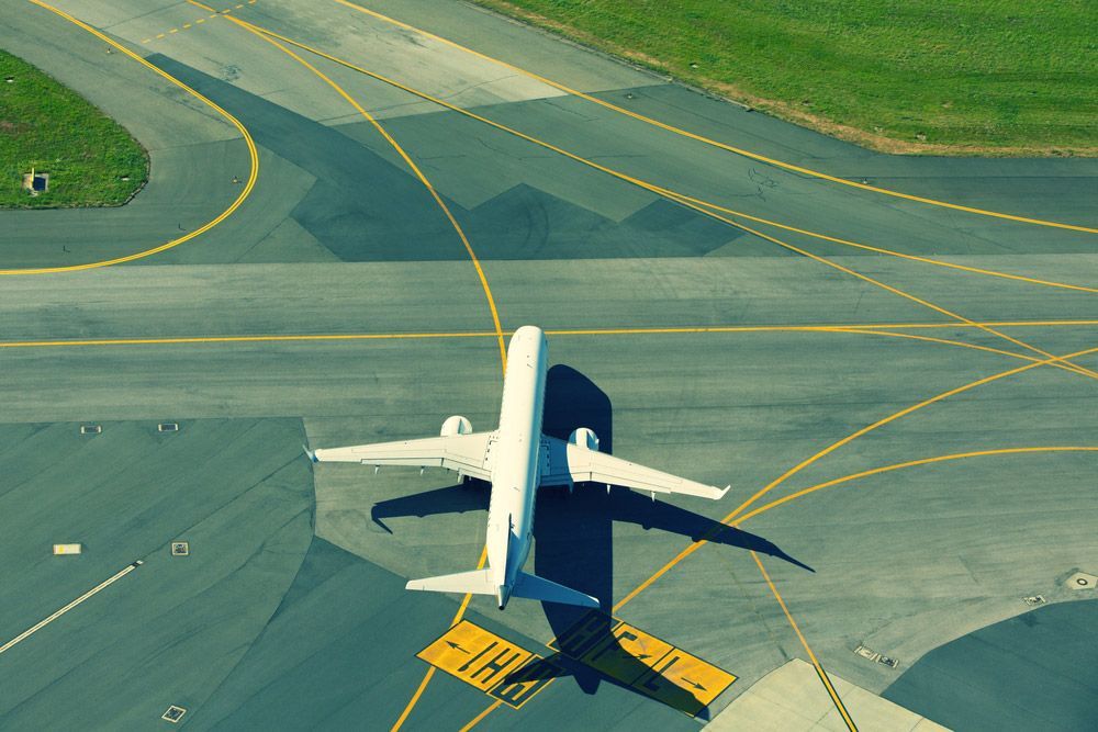 An Aerial View of An Airplane Taking Off from An Airport Runway — Top End Line Markers Pty Ltd in Katherine, NT