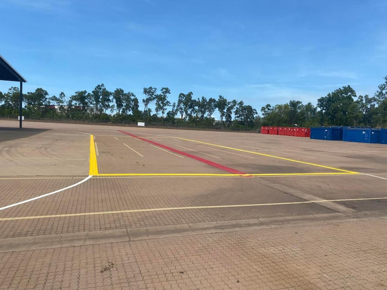 An Empty Parking Lot with Yellow and Red Lines on It — Top End Line Markers Pty Ltd in Katherine, NT
