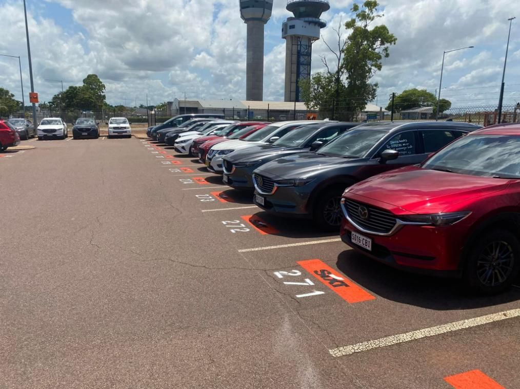 A Row of Cars Are Parked in A Parking Lot — Top End Line Markers Pty Ltd in Jabiru, NT