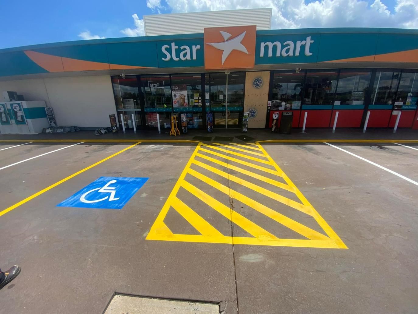 A Handicapped Parking Spot Is Painted in Front of A Star Mart — Top End Line Markers Pty Ltd in Katherine, NT