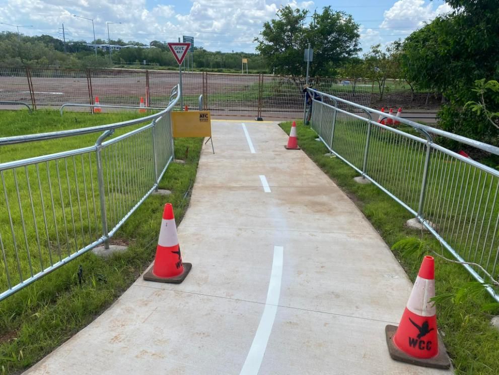 A Concrete Walkway with A Fence and Cones on The Side of It — Top End Line Markers Pty Ltd in Katherine, NT