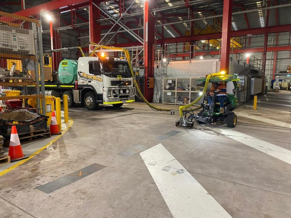 A Truck Is Parked in A Warehouse with A Hose Attached to It — Top End Line Markers Pty Ltd in Jabiru, NT