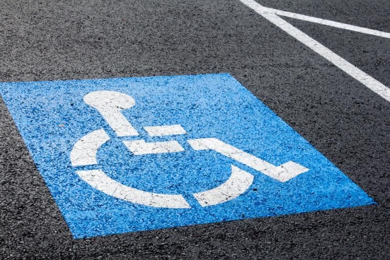 A Blue and White Handicapped Sign Is Painted on The Asphalt in A Parking Lot — Top End Line Markers Pty Ltd in Katherine, NT