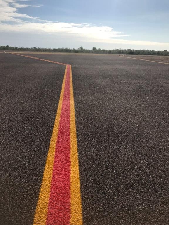 A Red and Yellow Line Is Painted on The Side of A Road — Top End Line Markers Pty Ltd in Katherine, NT
