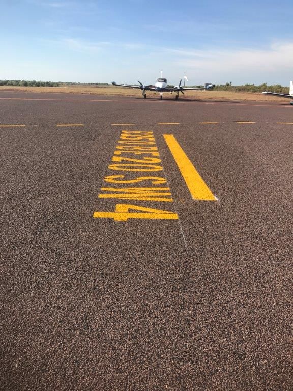 A Plane Is Sitting on A Runway with A Yellow Line that Says Arrivals Only — Top End Line Markers Pty Ltd in Katherine, NT