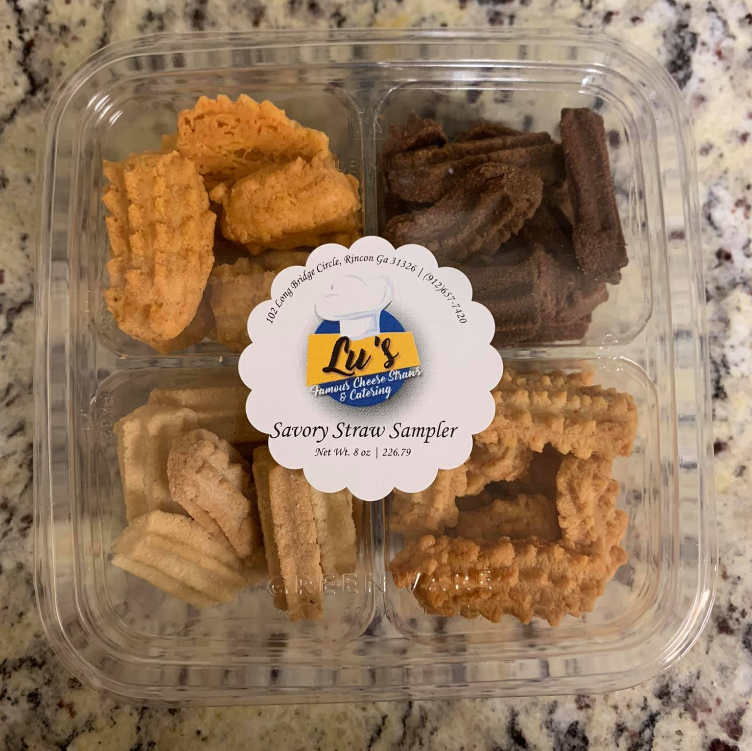 A clear plastic container filled with different types of cookies
