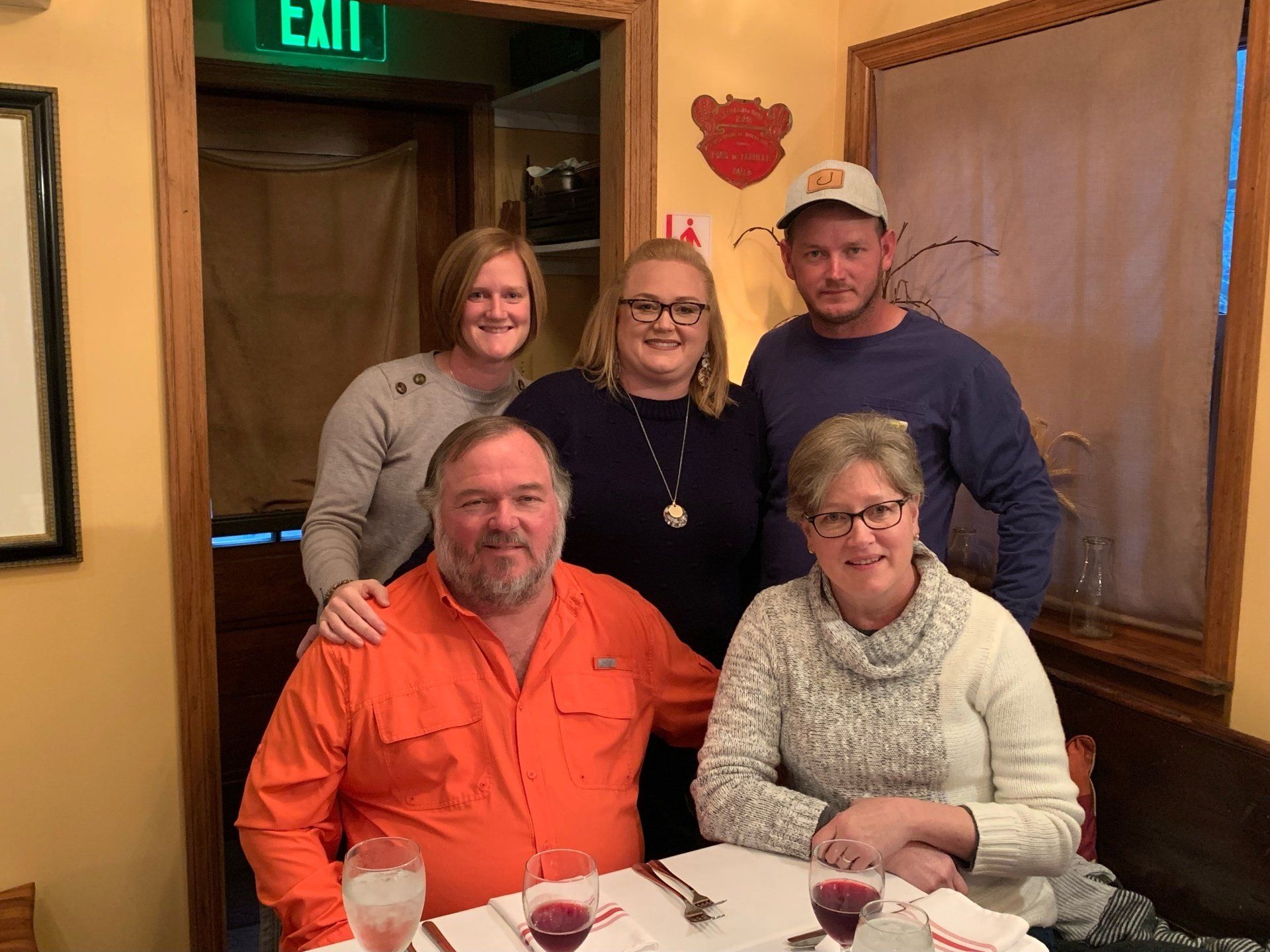 A group of people are posing for a picture in a restaurant.