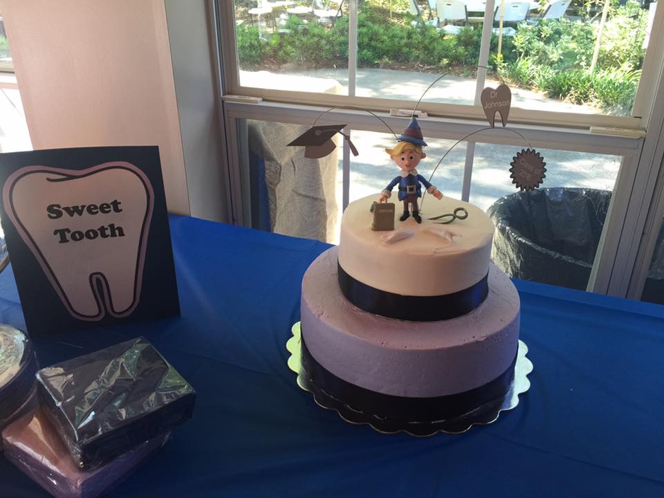 A cake on a table with a sign that says sweet tooth