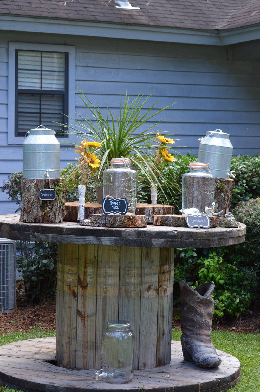 A wooden spool with a cowboy boot on top of it