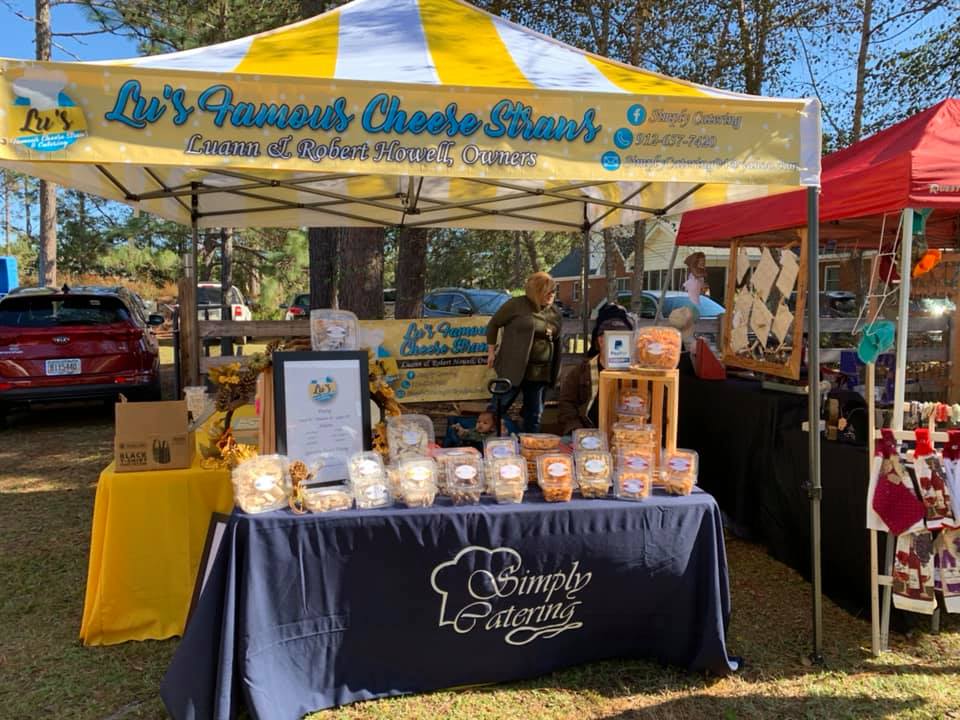 A table with food on it under a tent at a market.