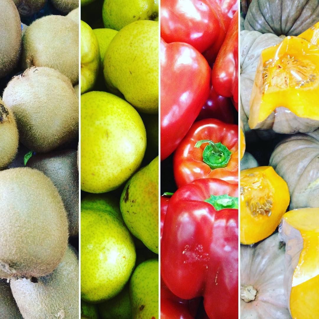 A variety of fruits and vegetables are sitting on a table.