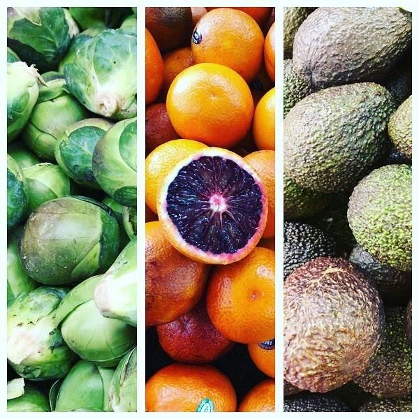A wooden table topped with a variety of fruits and vegetables.