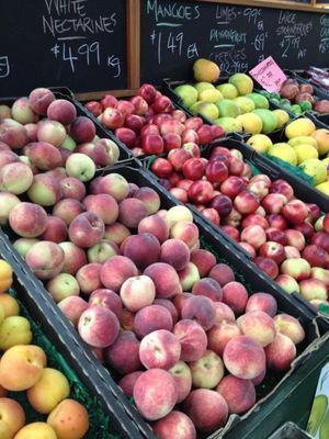 A variety of fruits and vegetables including peaches and apples