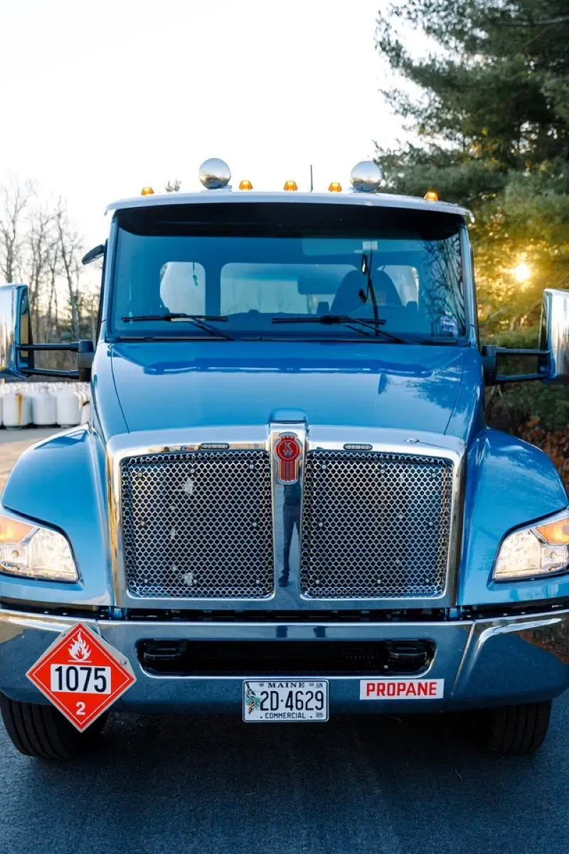 A blue truck with a red sign on the front that says 1079
