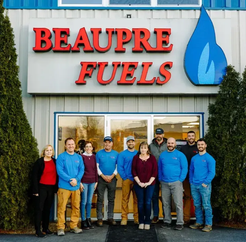 A group of people standing in front of a beaupre fuels store