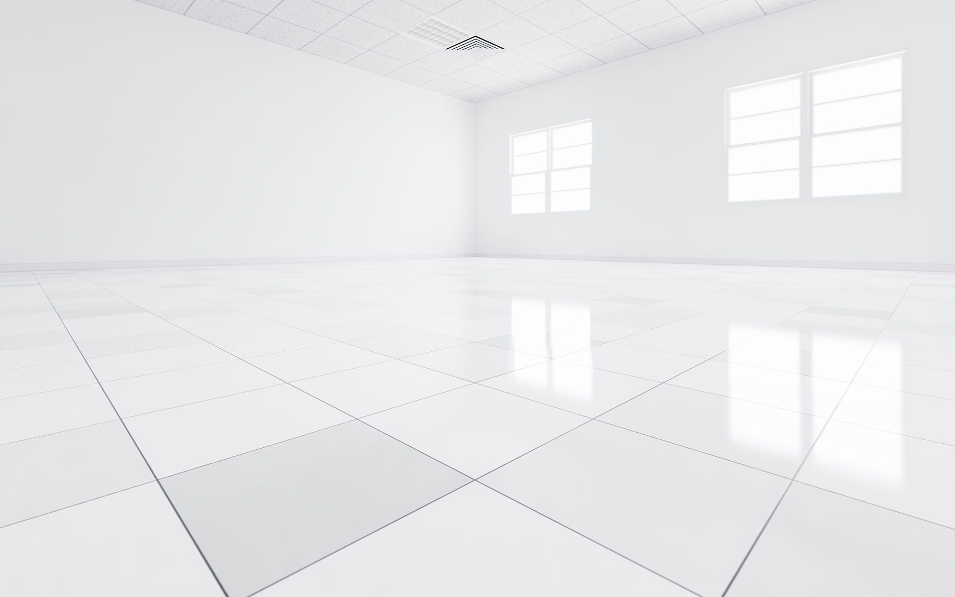 An empty room with white tile floors and windows.