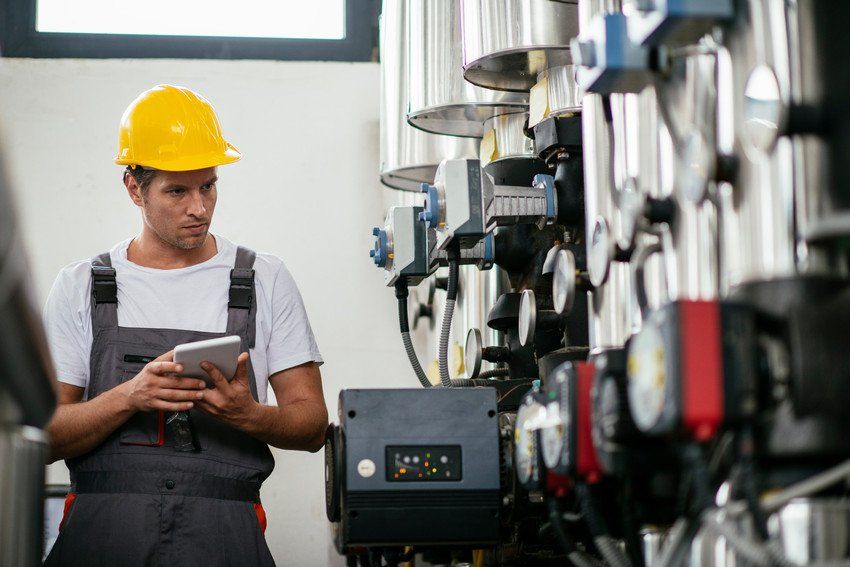 A man conducting checks on industrial machinery