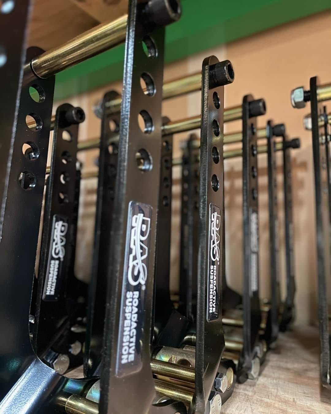 A person writing on a clipboard while inspecting the open engine bay of a car.